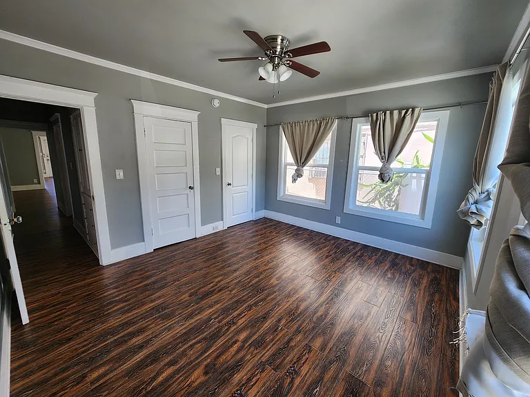 Bedroom with 2 closets and 4 windows.