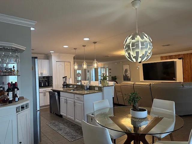 Bright open-concept layout connecting kitchen, dining, and living areas_perfect for entertaining.