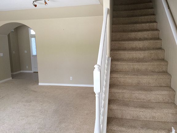 Living room, stairs to bonus room and 1/2 bath