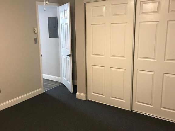 Master bedroom - carpeted with with double closets, and additional closet at the opposite wall.