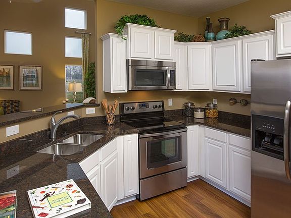 Tiered cabinetry and great options like granite countertops and stainless appliances highlight this