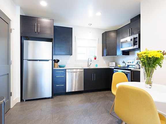Modern kitchen with everything needed for preparing meals. Laundry room behind door on left.