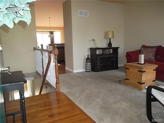 Wood Floor Entry into Great Room, partial 3/4 wall divides this