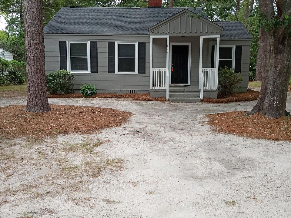 Cute front yard with front porch, with beautiful shade trees.