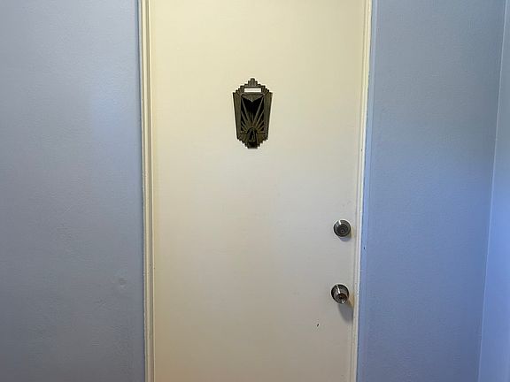 There is a large secured door to enter into the building which opens to the foyer from the street and each unit has its own front door two downstairs and 2 upstairs. Oh, that ornamental piece on the front door is a functional speakeasy.