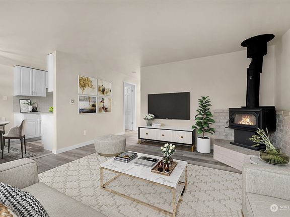 Virtually staged family room with wood burning fireplace>