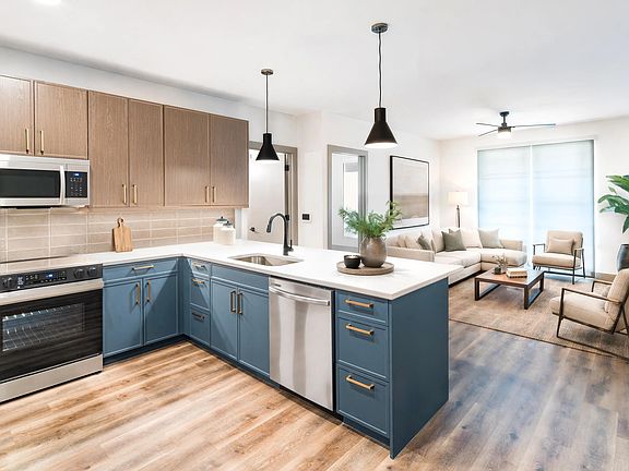 An open kitchen and living space with warm finishes, ample prep room, and a comfortable flow for everyday living.