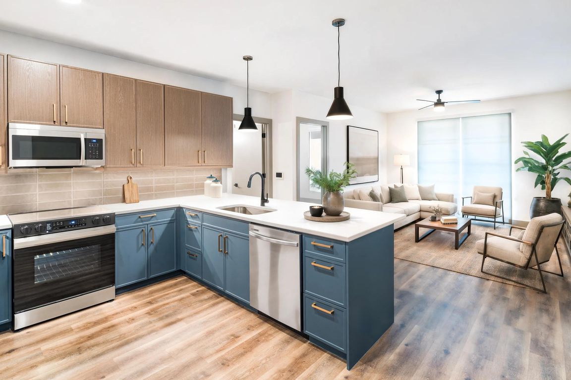An open kitchen and living space with warm finishes, ample prep room, and a comfortable flow for everyday living.
