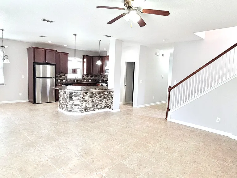 Another view of Living and Kitchen with large independent Island.