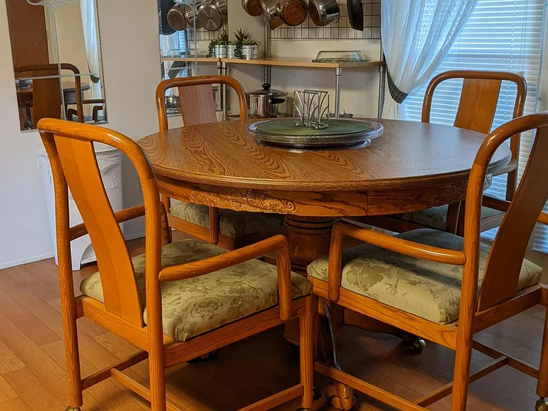 Dining table and 4 chairs. Note bakers rack in the background for easy access to pots and pans.