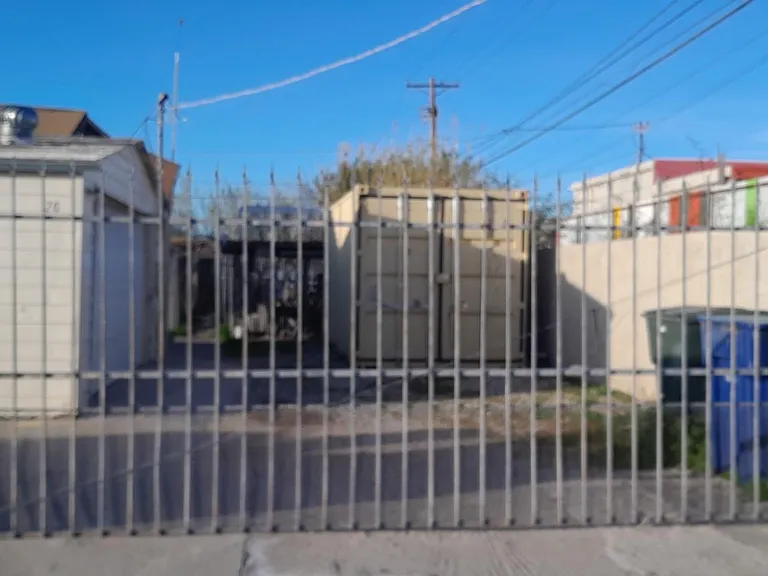 6' perimeter block wall with 6' wrought iron gate, wire cross fencing, off street parking. Lockbox with keys.