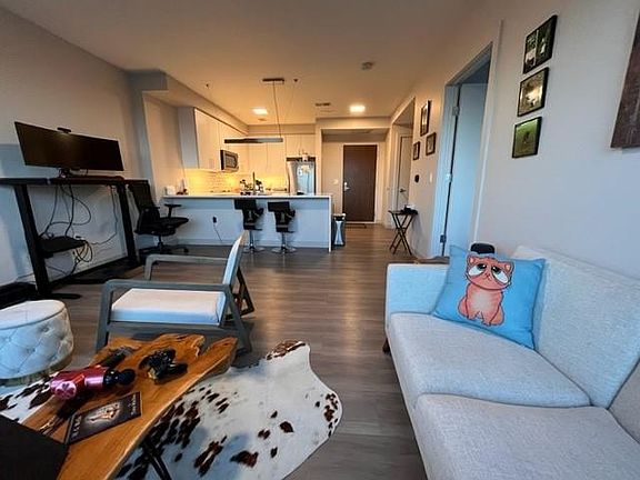 View of Front Door and Kitchen from the Living Room side. **Only Unit for Sublet. Furniture & Furnishings are not included.