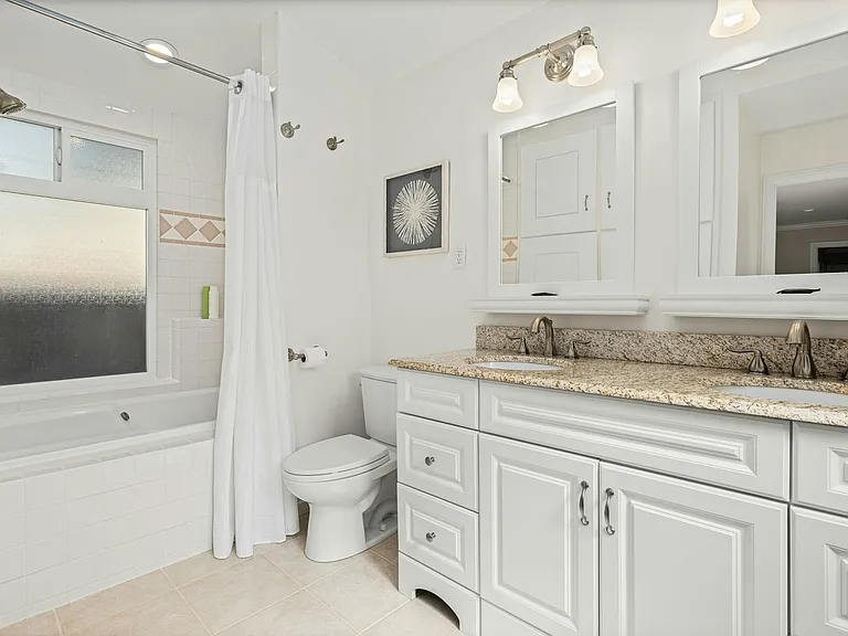 Crisp, clean, and family-ready featuring a double vanity, full tub/shower combo, and abundant storage, this bathroom is ideal for busy mornings or a relaxing evening soak.