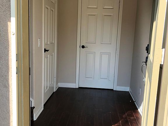 Hallway. Left staircase leads up to living area.