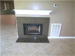 Fireplace with granite surround.  Imagine Christmas here with a warm fire and decorations.