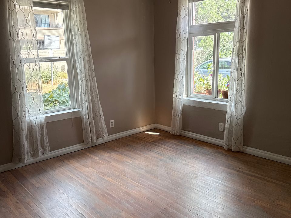 Office or 2nd bedroom with tall ceilings, wood floors and wardrobe.