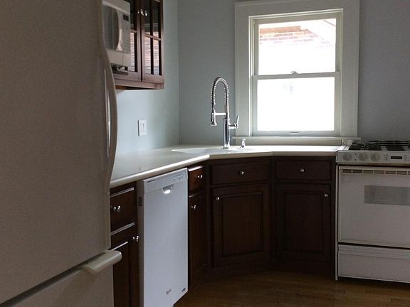 The kitchen has cherry cabinetry with glass doors, a terrifi