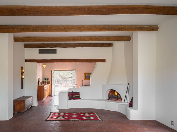 Living room, kiva fireplace looking into dinning room.