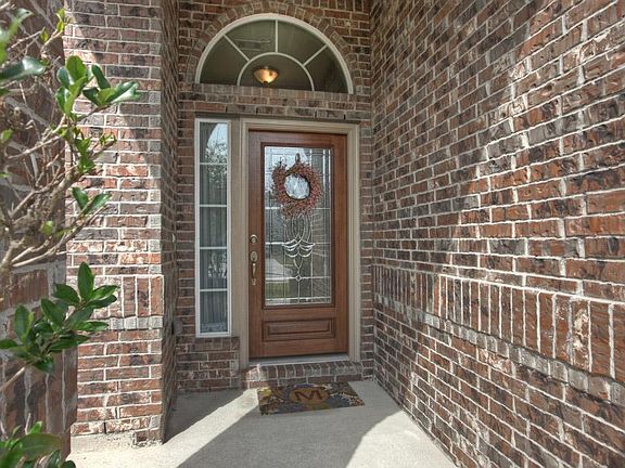 Beautiful brick entry and leaded glass door.