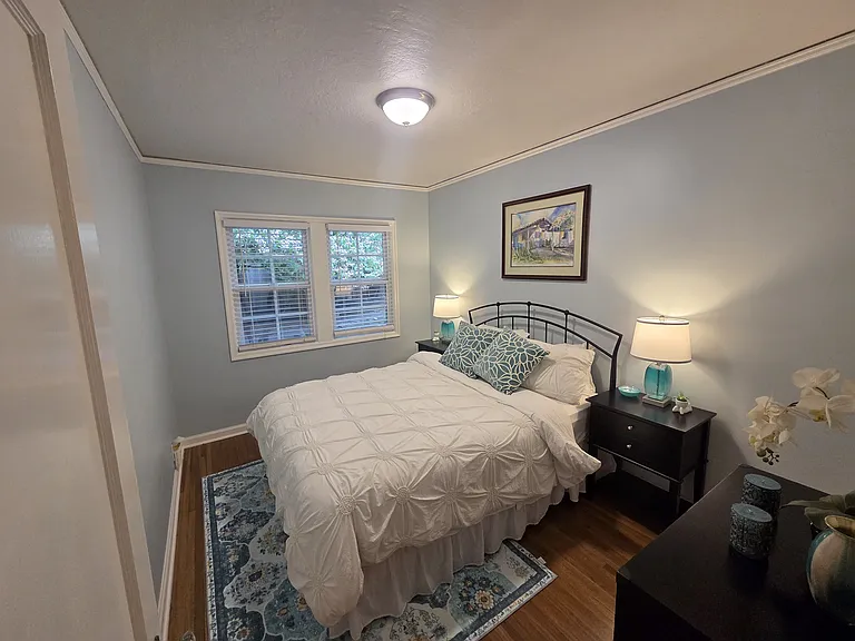 With a comfortable queen bed and a convenient main-floor location, this lovely bedroom is a perfect retreat.