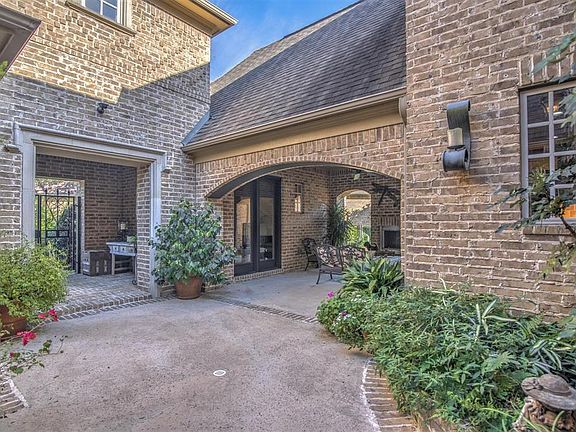 Front entry gate with covered area and large covered living area patio with fireplace connected to the en-suite bath Casita that would be great used as a guest, office, or studio area.