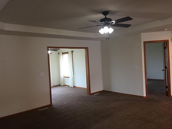Looking through the living room to the sunroom and the master bedroom door.