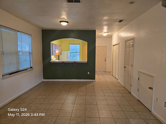 Living Room showing entrance and Kitchen. The side has half bathroom, washer/dryer hookup and the cost closet.