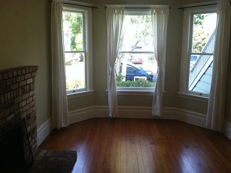 Living room is at the front of the house with fire place.