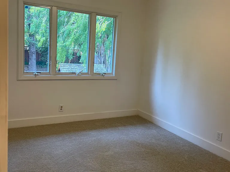 Bedroom with view of the backyard