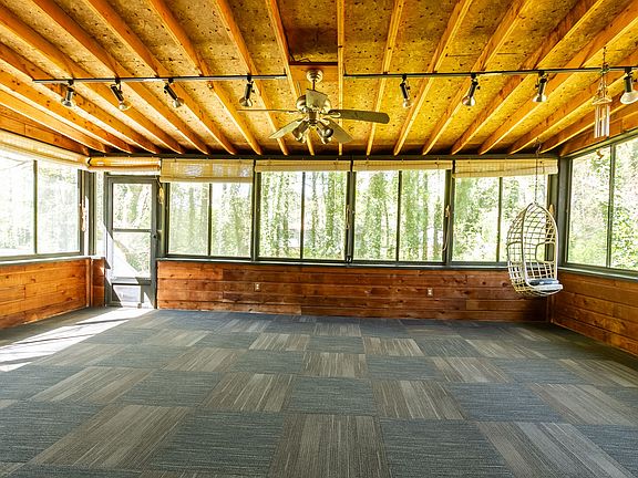 Large enclosed sunroom/patio overlooking the peaceful backyard