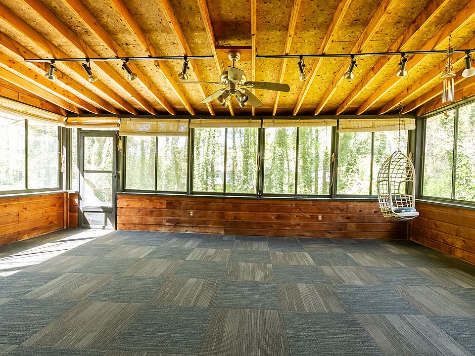 Large enclosed sunroom/patio overlooking the peaceful backyard