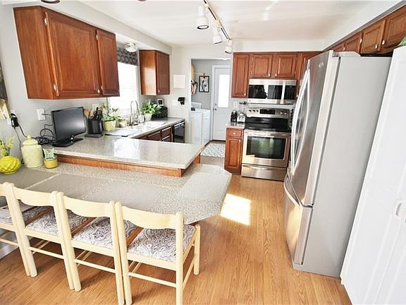 This gourmet kitchen is a treat with stainless steel appliances, warm wood cabinetry, generous counter space,and unique island w