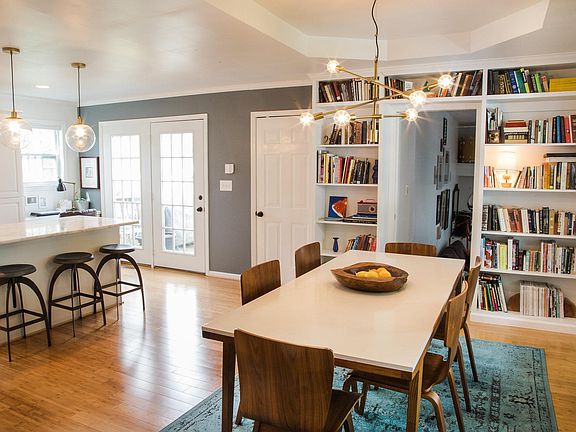 Open kitchen w/ marble countertops, subway backsplash, SS ap