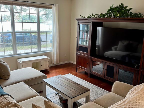 Hardwood floors in living area with huge window overlooking the water!