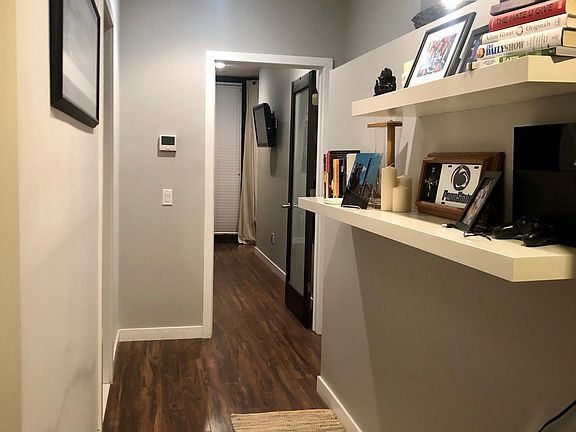 Hallway between office/den and bedroom (bathroom door to the left).