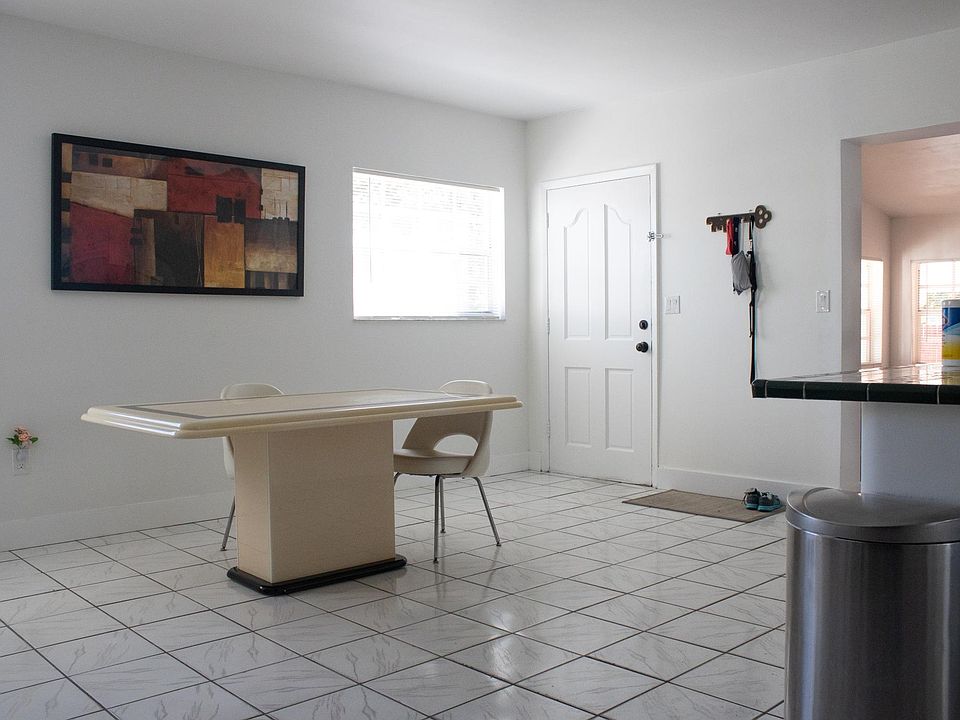 View of dining/living area. The door is the front entrance.