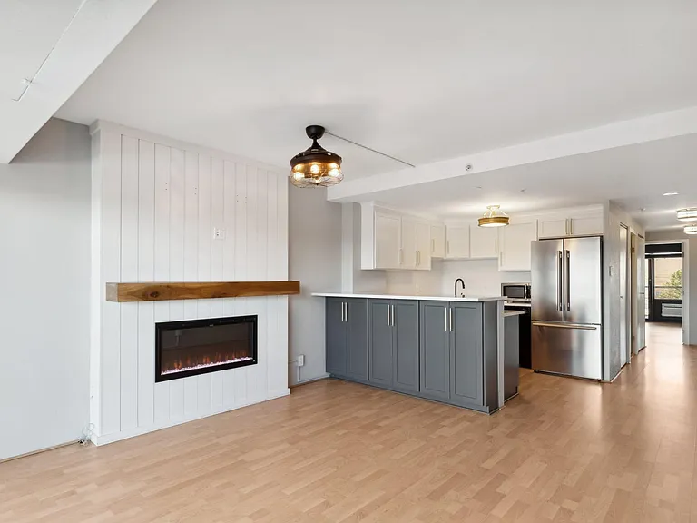 Main living area with smart electric fireplace (optional heat feature).