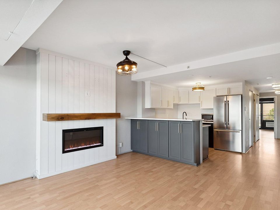 Main living area with smart electric fireplace (optional heat feature).