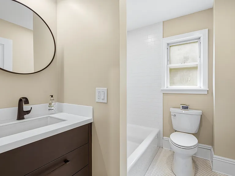 The bathroom sits between the two bedrooms and features natural light as well as beautiful lighting. The designer tiling in the brand new bathroom sparkles in your new oasis. It's all in the details!