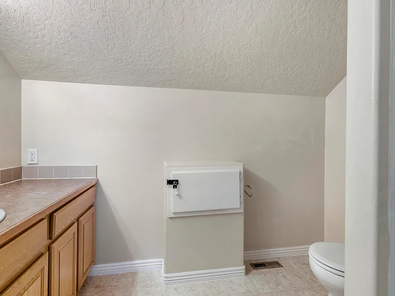 Upstairs full bathroom with a shower and laundry shoot