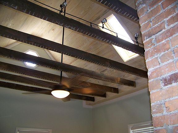 Living room ceiling with original beams exposed; skylight.