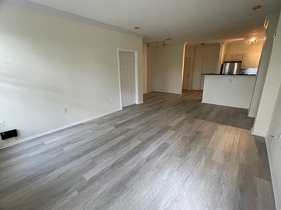 View from the living room toward the dining nook, kitchen and front door