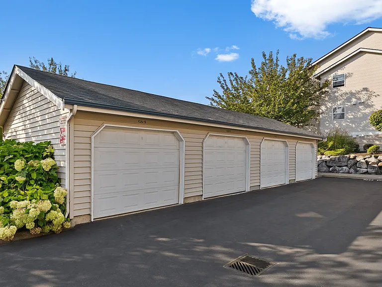 The community offers a clean, well-lit underground parking garage with ample space, concrete support columns, and convenient access for residents' vehicles, ensuring safety and protection from the elements.