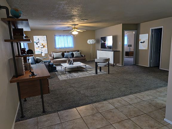 Very large living room with room for several different configurations. You can add a desk or formal dining table. Furniture staged.