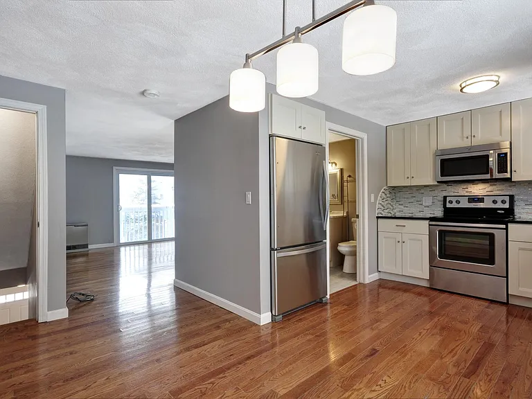 View from dining area into kitchen and living room