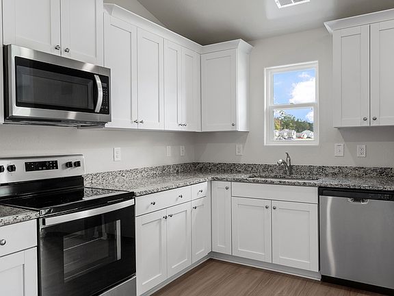 Stainless steel appliances are included in the kitchen
