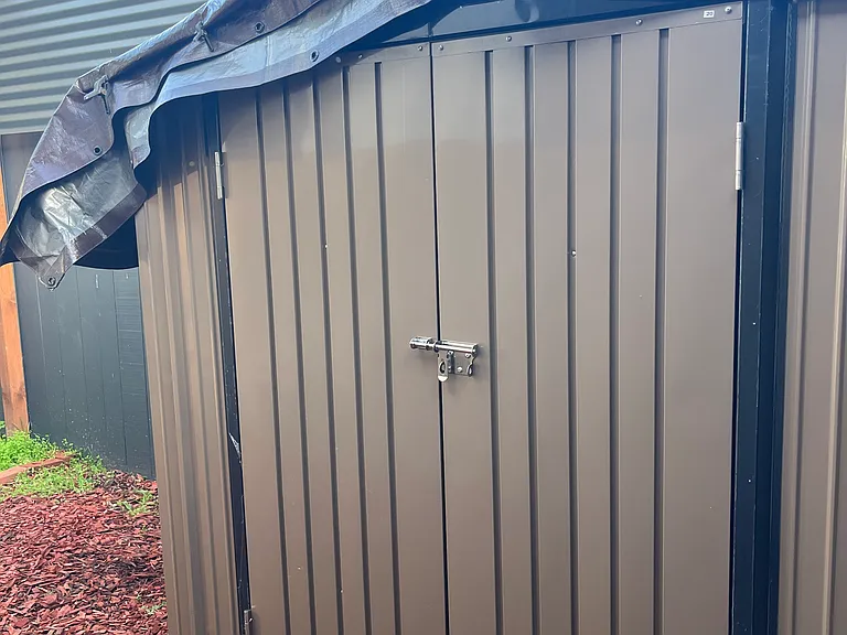 Brand new 6 x4 storage shed.
I covered it with a tarp due to the upcoming rain.