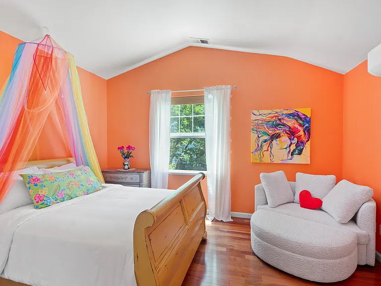 "The Rainbow Room" with cozy queen bed and another comfy chair.