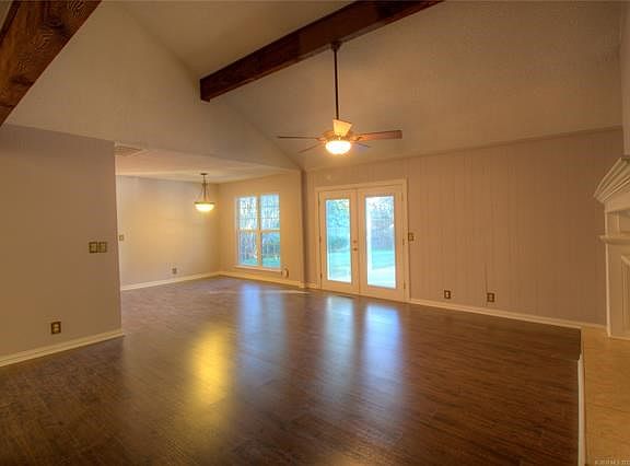 Another view of the living area with exposed beams.