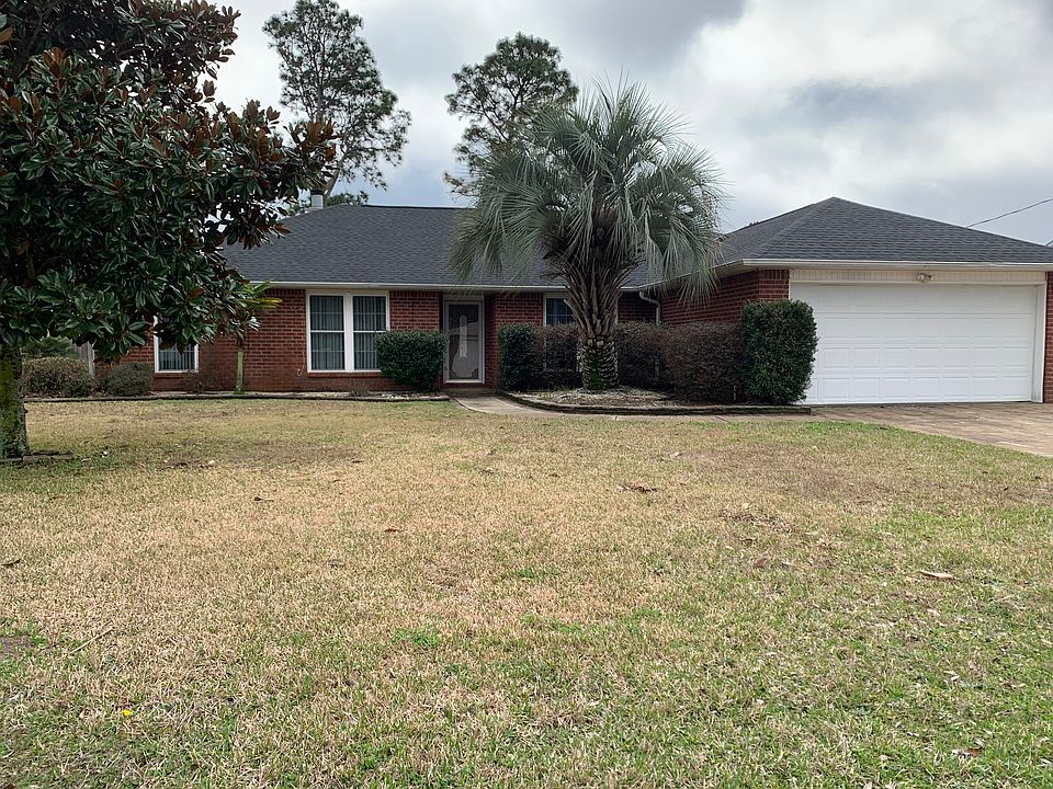 Mature lawn with sprinklers in front